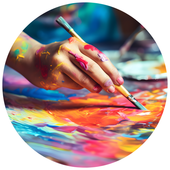 A female artist's hand grips a paintbrush, her fingers splattered with vibrant paint, as she works on a canvas bursting with color.